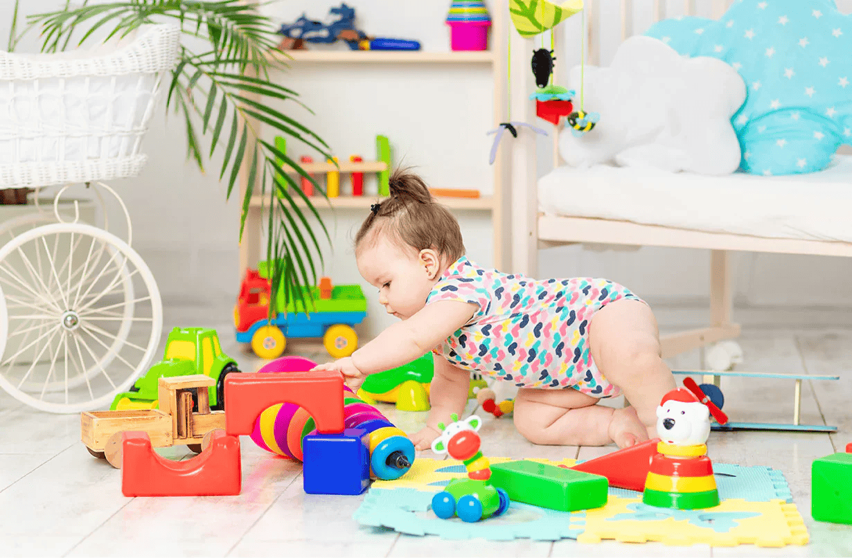 Toddler playing with Montessori stacking rings for fine motor skills